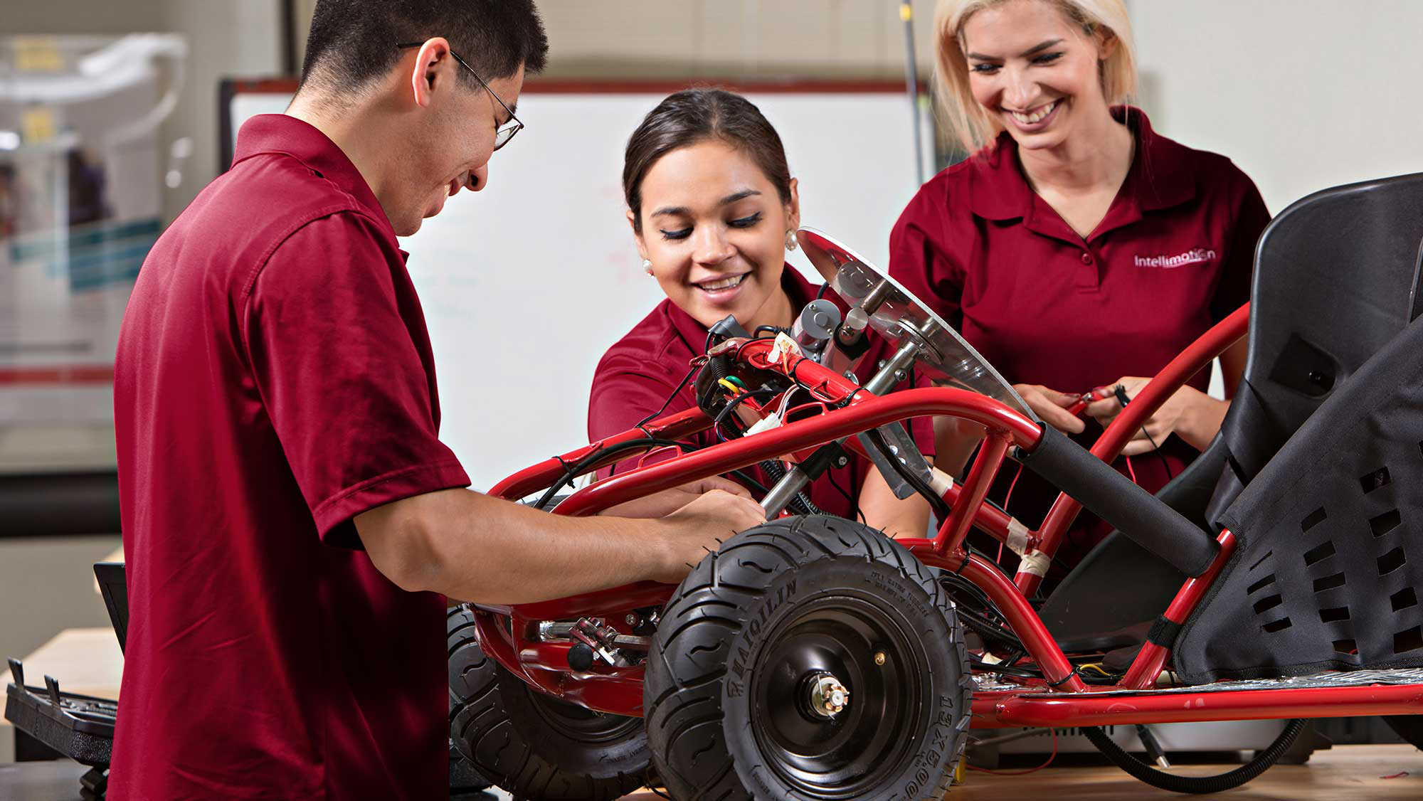 engineering students work together to build a motor vehicle