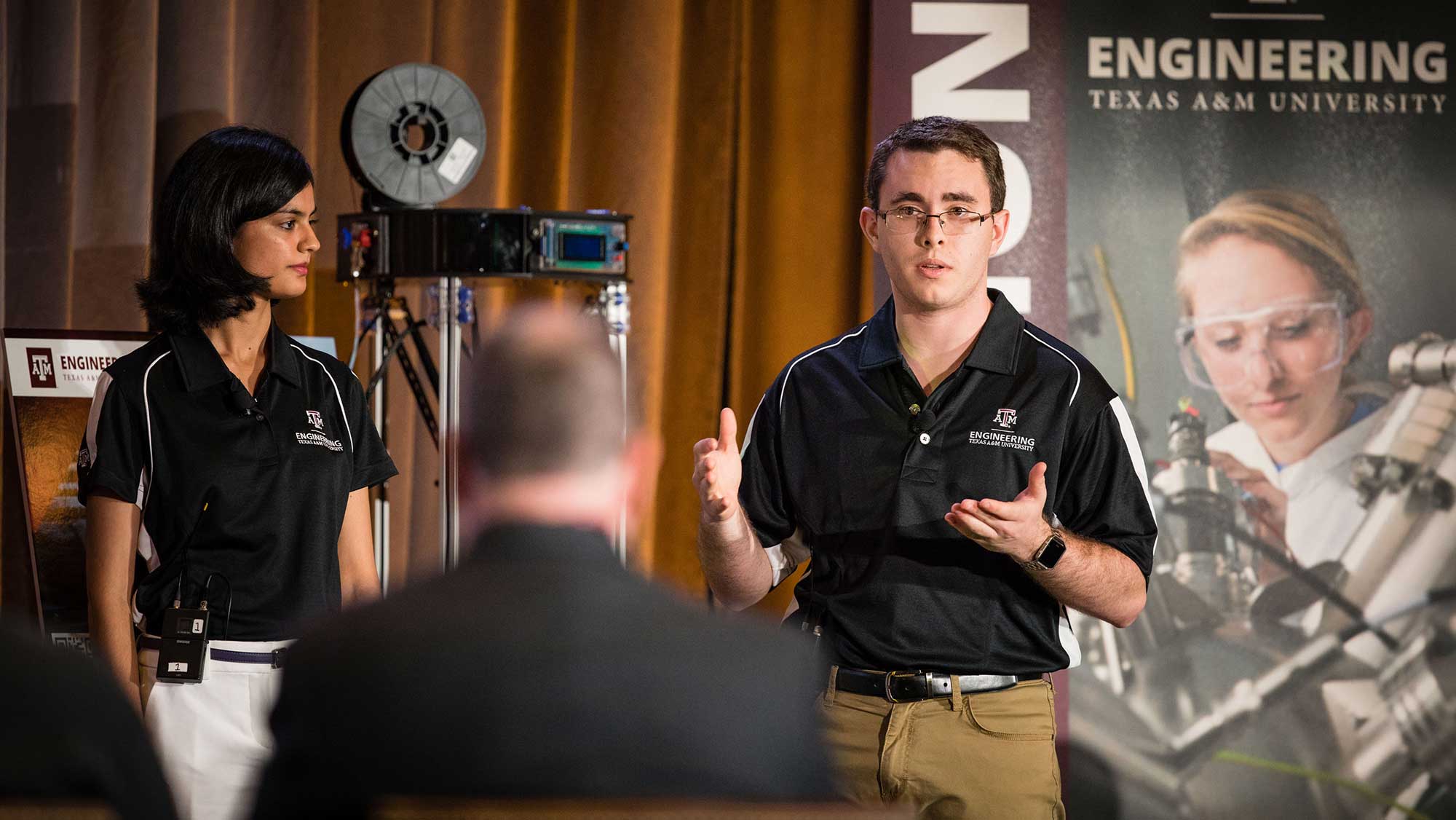 engineering student representative speaking to a crowd at an event