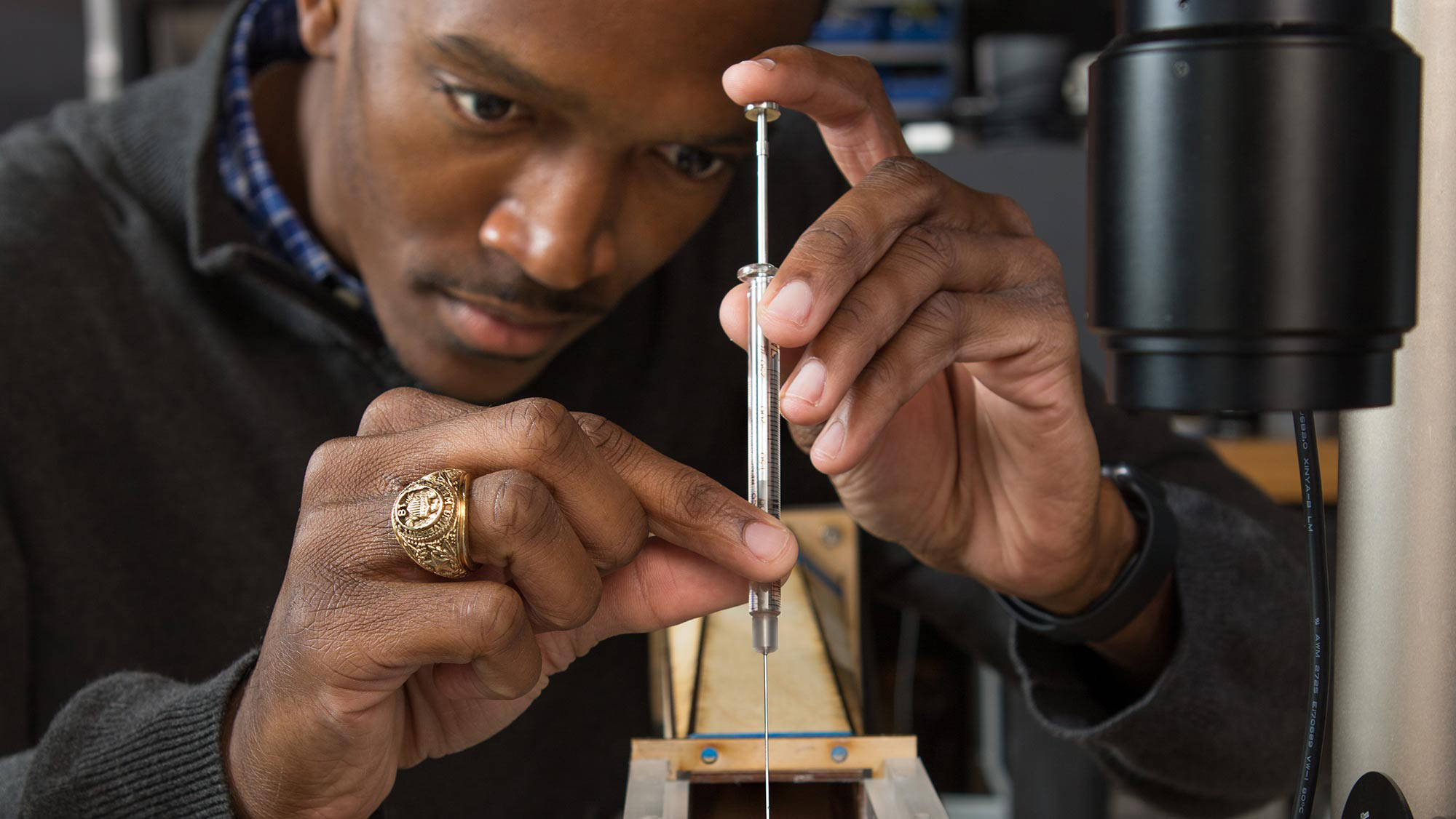 student working with a small wind tunnel