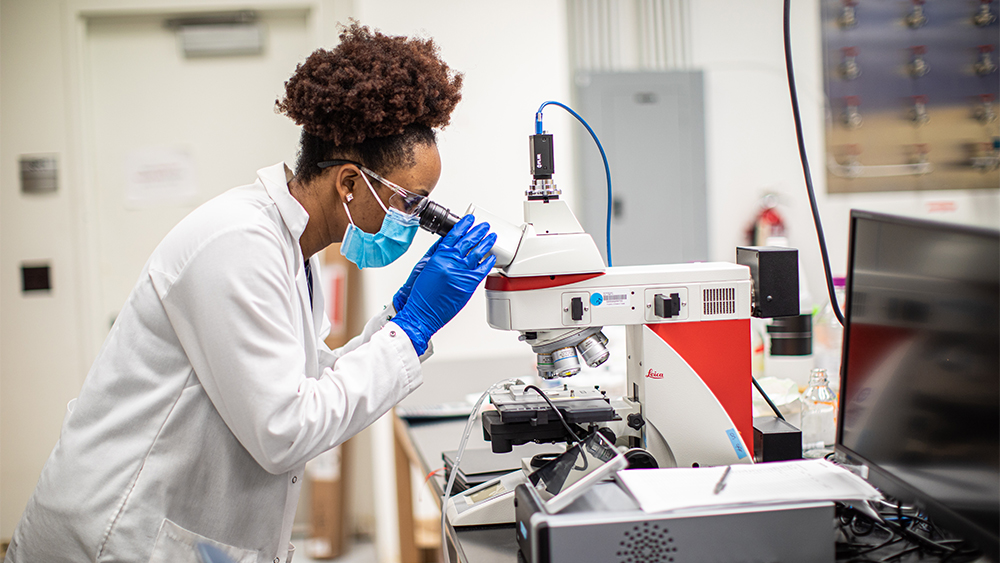 Woman looking through a microscope