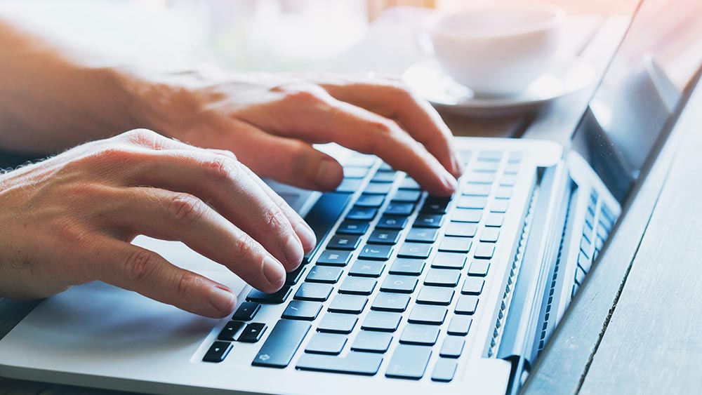 typing on a laptop computer keyboard