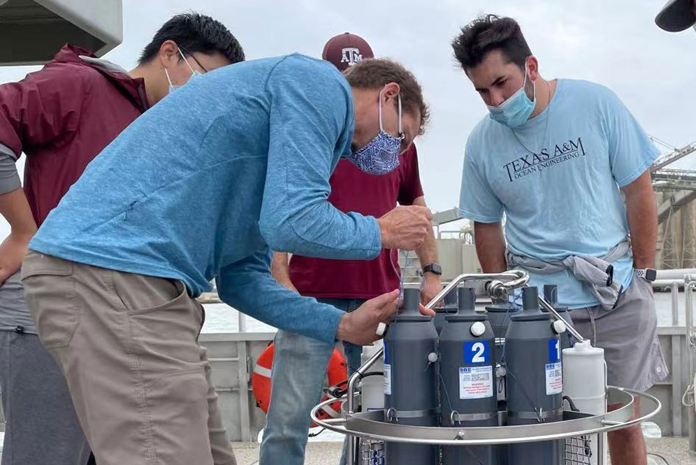 A group of graduate students performing a field test