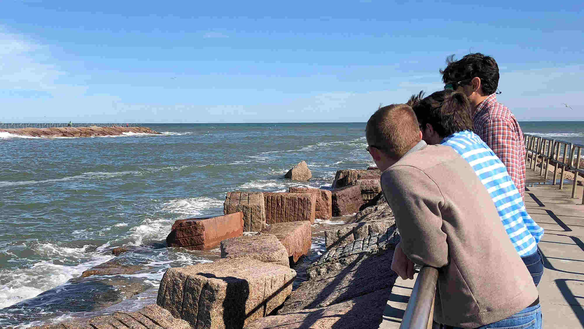 students looking out over the Packery Inlet